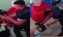 Markette eşiyle tartışan kadını saçından tutup yerde yumrukladı!